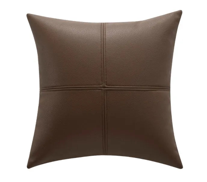 Simple solid colour cowhide leather pillow cover on a sofa, shown in a beige white colour.