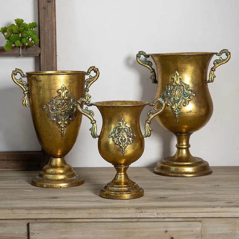 Metal decorative vase with black and gold finish, modern simplicity design on a tabletop