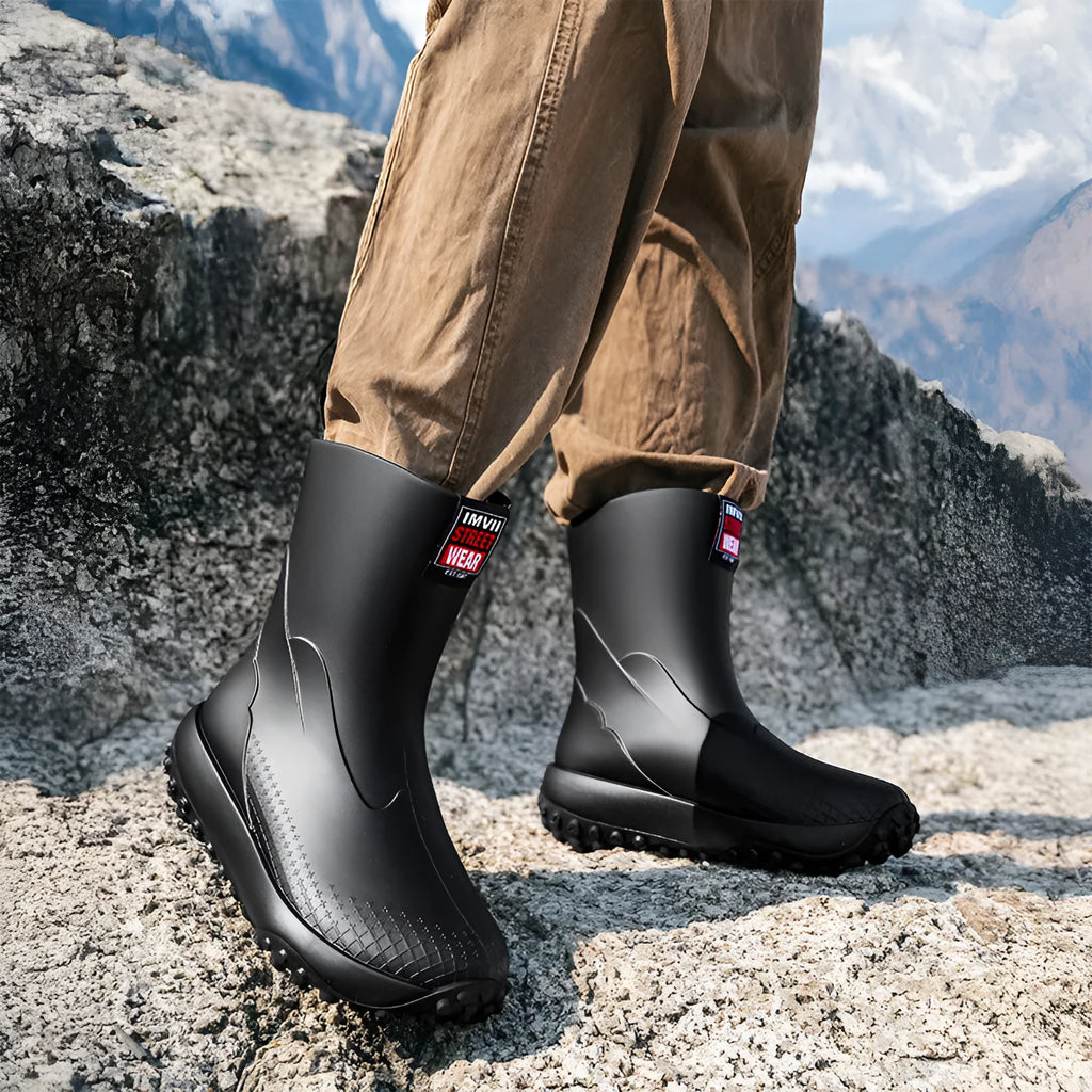 Men's mid tube PVC rain boots in black with non-slip plastic sole, round toe, flat heel