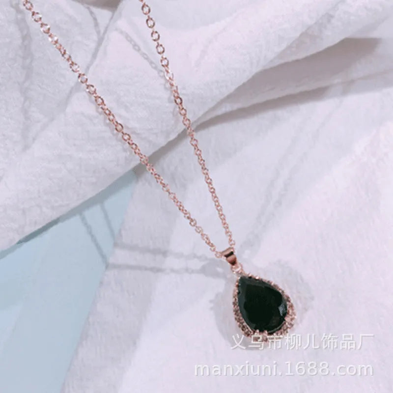 Rose gold geometric drop necklace with rhinestone details in pink colour option