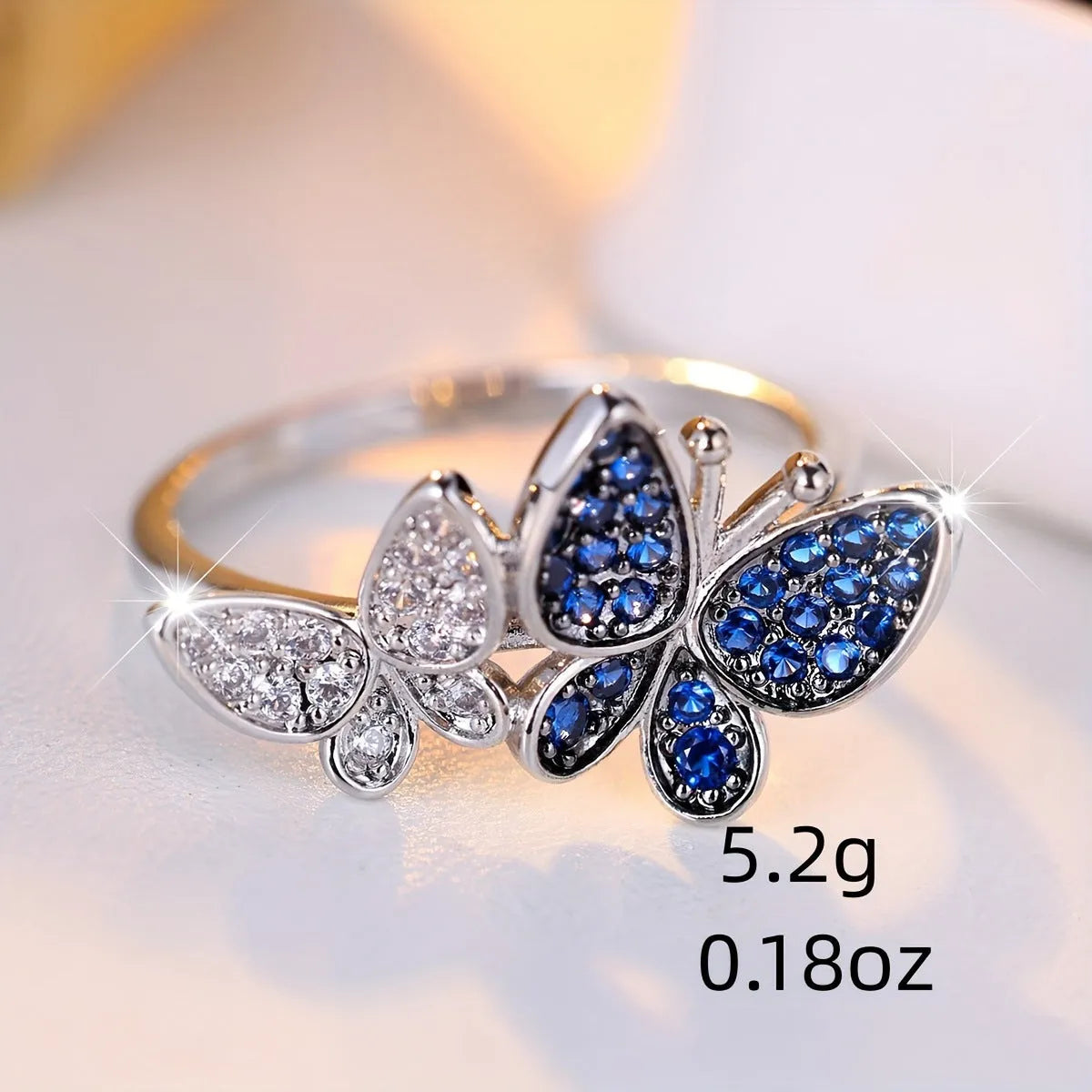 Blue and white copper butterfly ring for women TJZ40135 on plain background