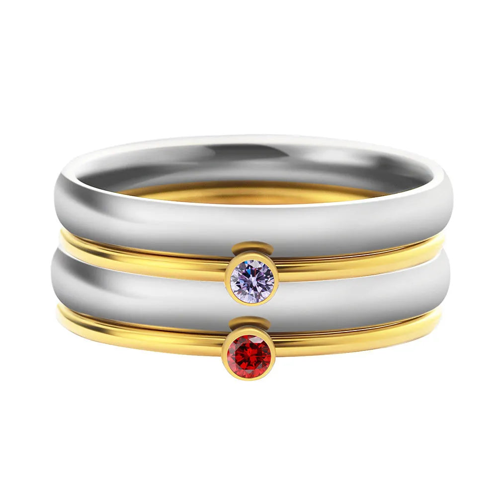 Close-up of a geometric titanium steel ring with December birthstone and engraved pattern, shown in one of three colour options.