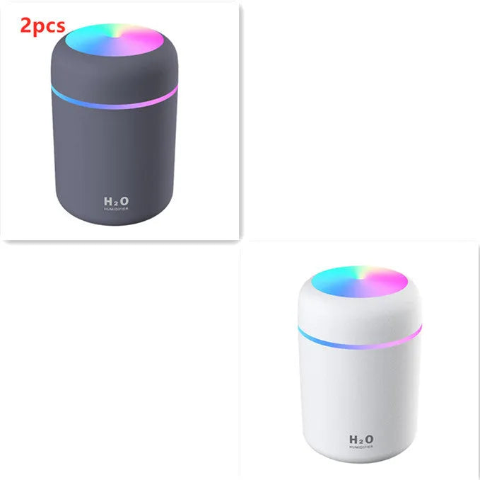Pink USB desktop humidifier with colourful LED lights and 300ml water tank on wooden desk
