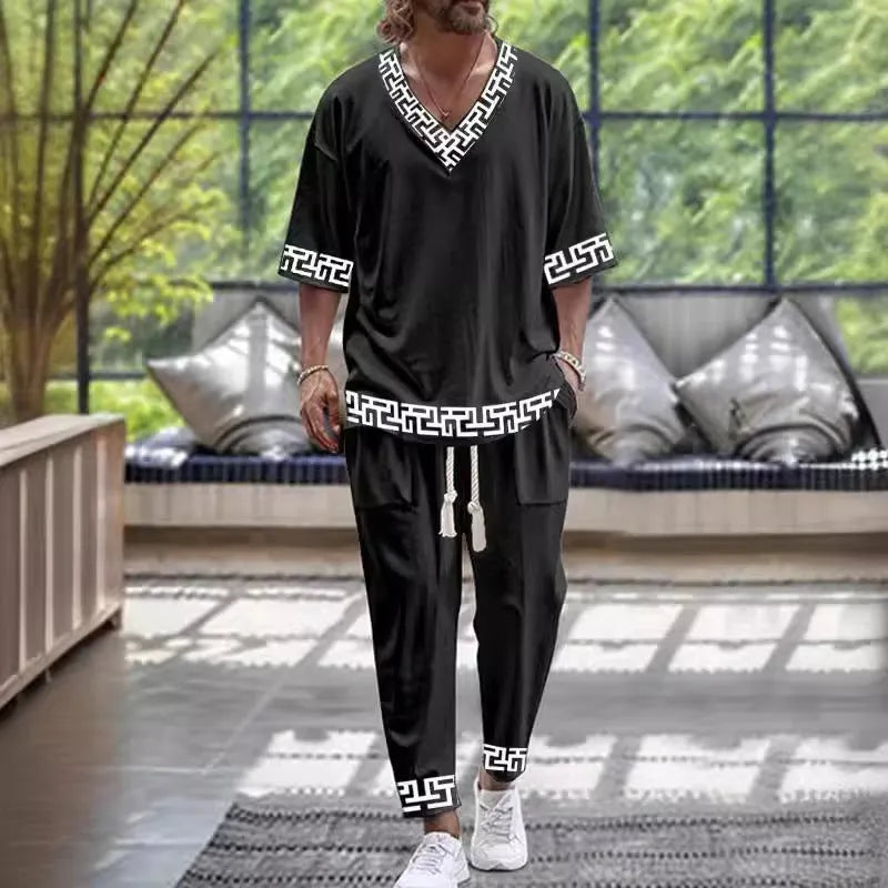 Thin polyester fibre co-ordinated suit with V-neck top, cropped sleeves, and matching trousers on a hanger.