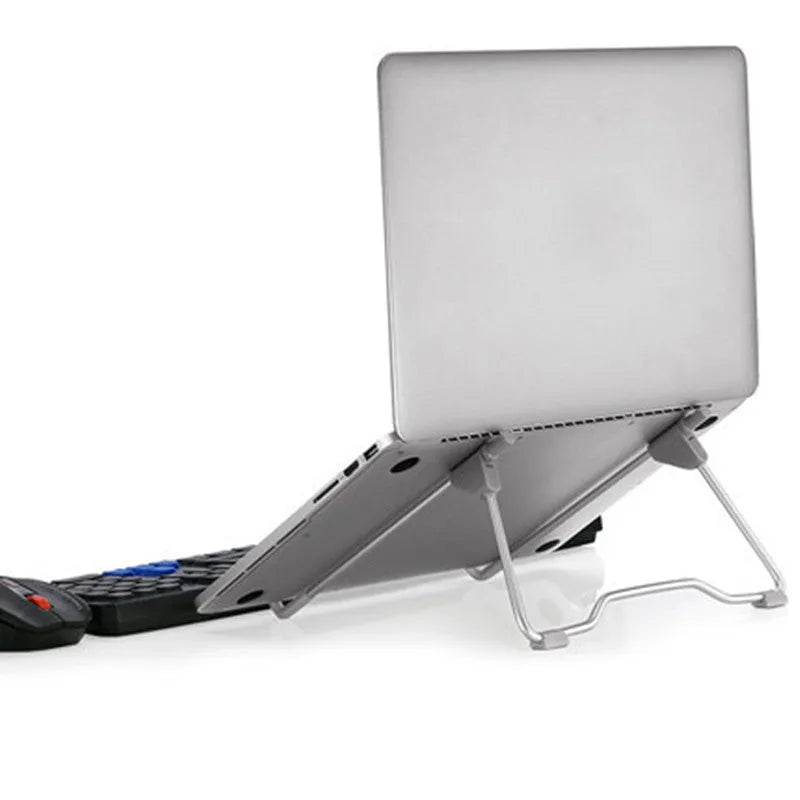 Grey aluminium alloy and plastic mobile phone and laptop stand combo on desk