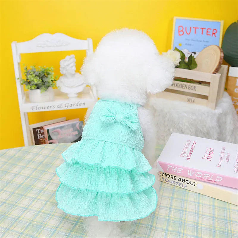 Small dog wearing polyester princess dress with candy layered skirt in water green colour