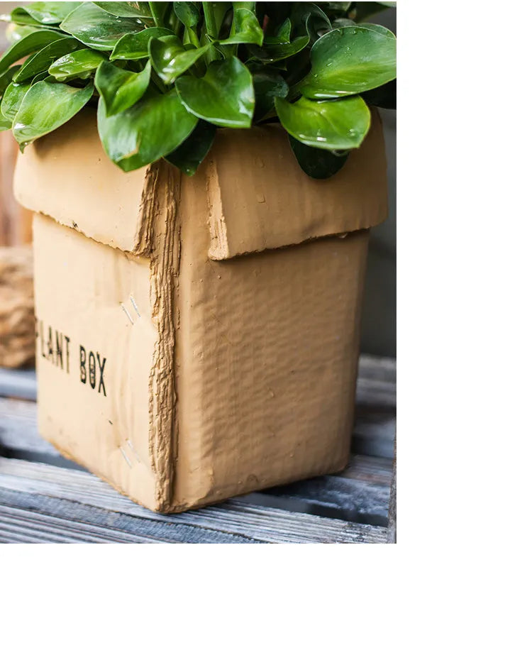 Cement brown paper box style flowerpot with a drainage hole, shown in a Nordic interior setting.