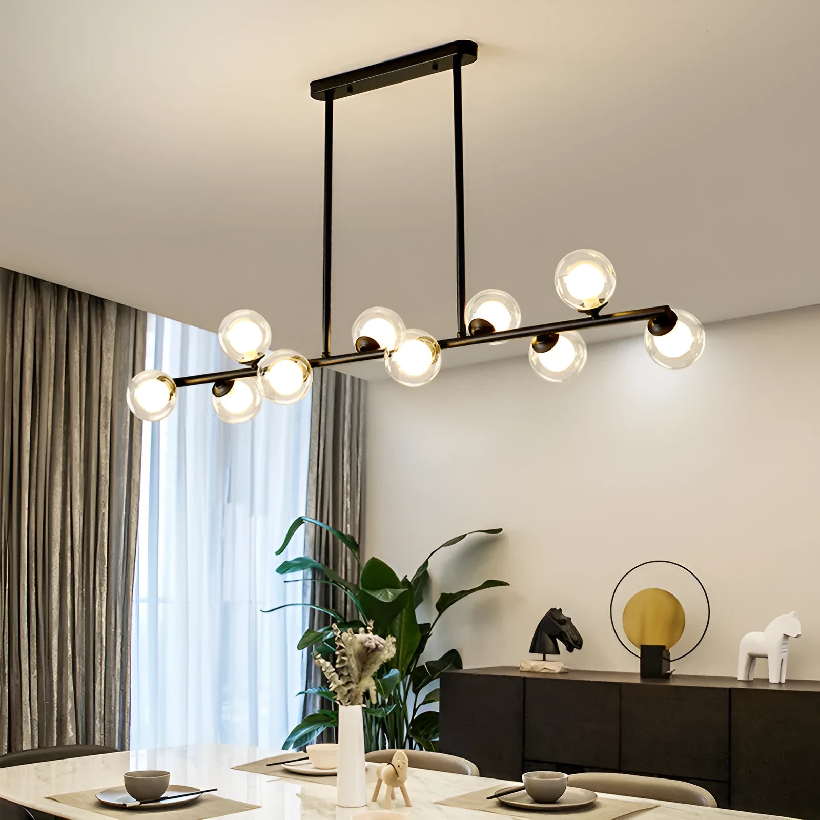Modern minimalist glass bubble ball chandelier with black iron body and clear glass shades in a Nordic style