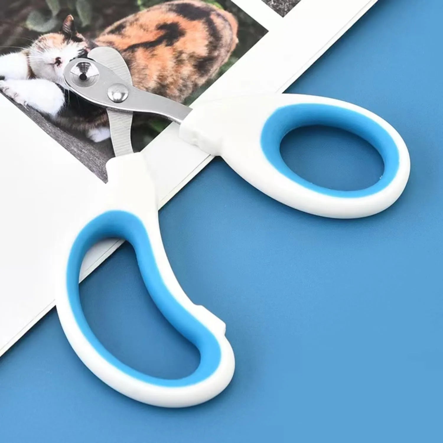 Blue professional cat nail clippers with circular safety hole and cushioned non-slip handles.