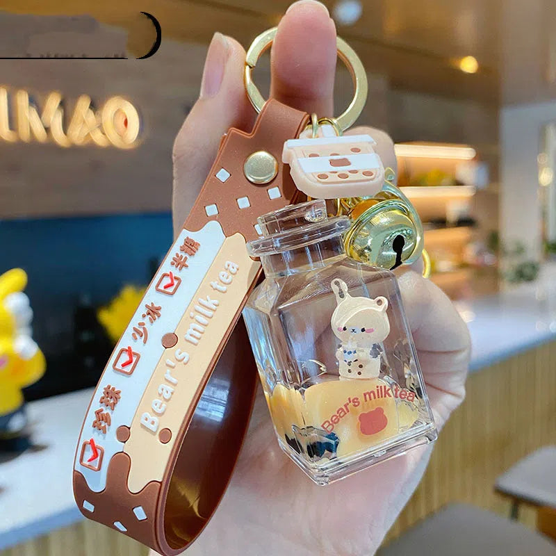 Oil-infused pearl milk tea bear keychain pendant in clear acrylic with alloy ring, featuring a drink bottle style design