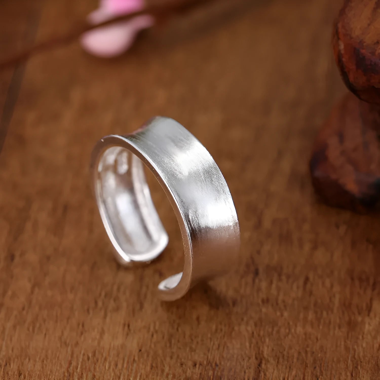 Open geometric ring in frosted sterling silver with an adjustable band.
