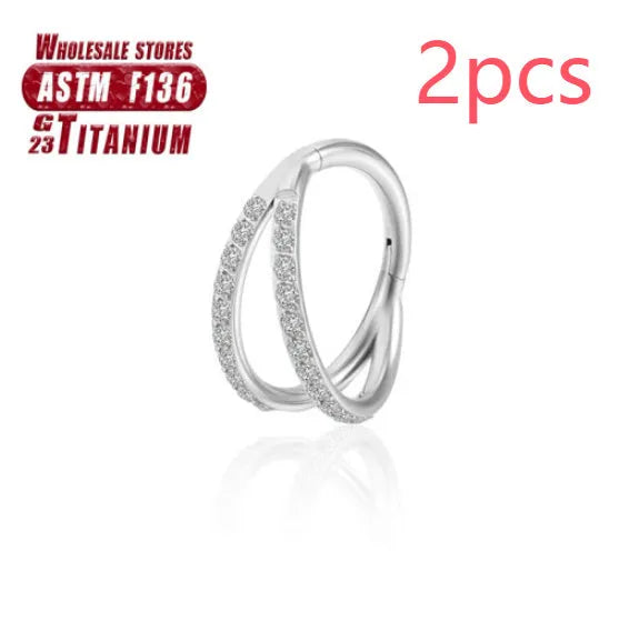 Close-up of a titanium alloy nose ring with a fork closure, shown in silver finish on a grey background.