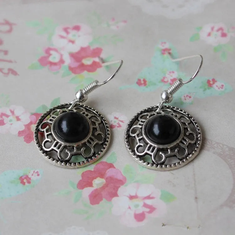 Handmade geometric flower disk earrings in Tibetan silver and turquoise with ethnic Miao design.