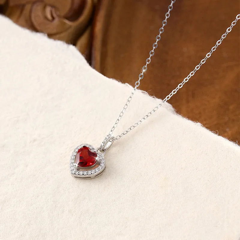 925 silver necklace with heart-shaped pendant containing natural gemstone on cross chain
