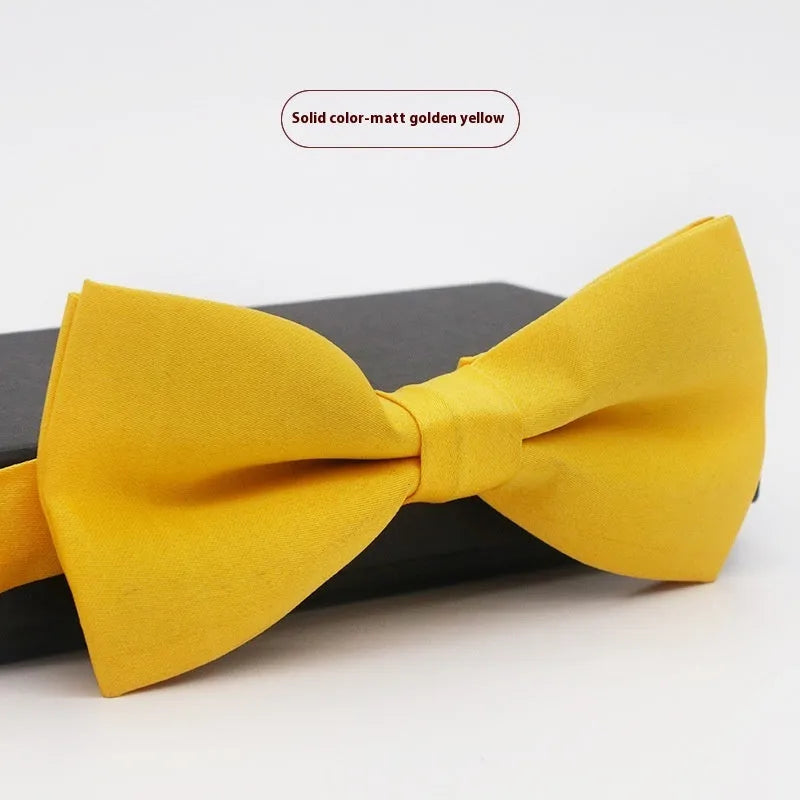 Solid colour flat head bow tie for formal wear in multiple colours including black, red, and blue.
