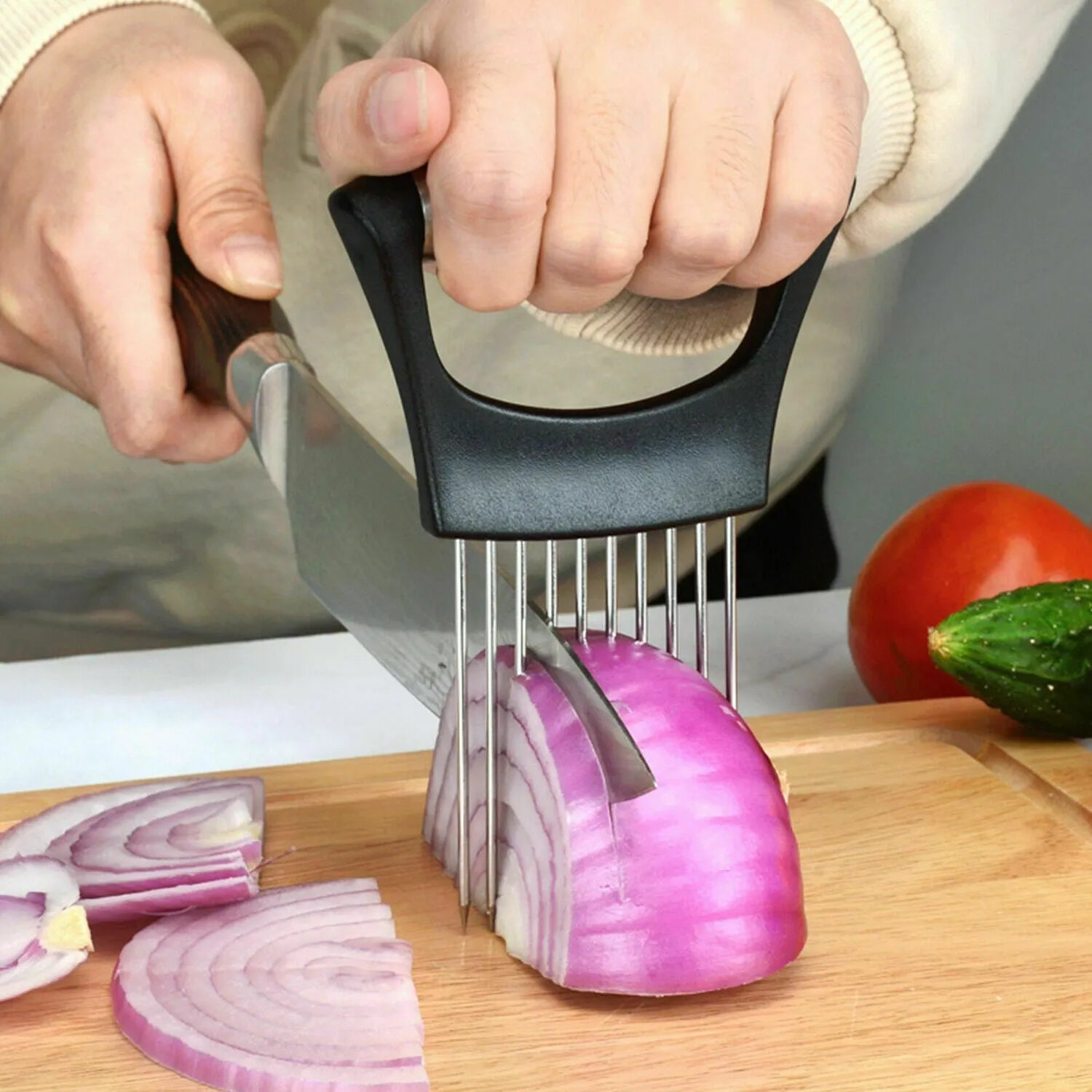 Stainless steel onion and tomato slicer holder with ABS handle on a kitchen counter