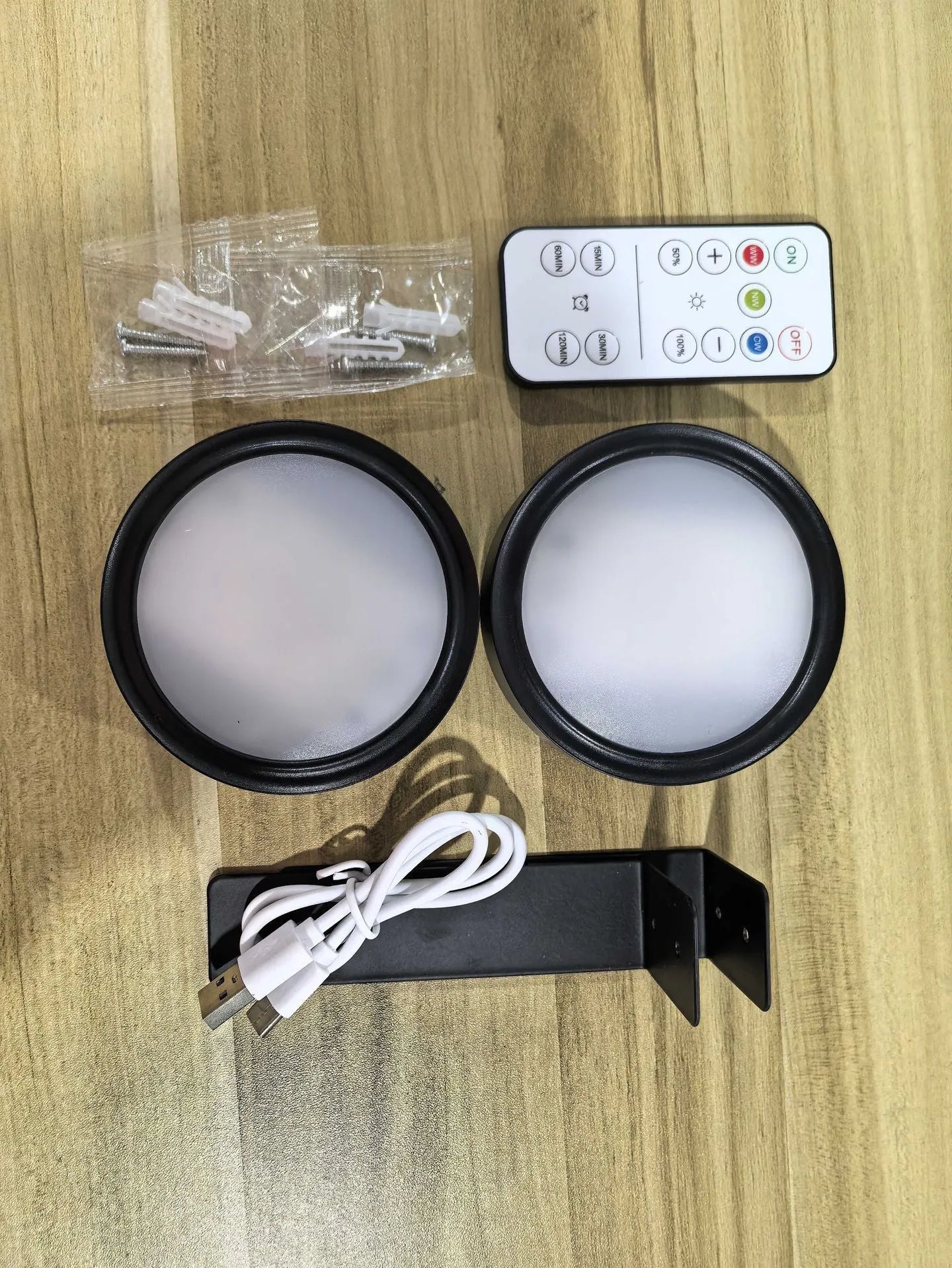 Wireless LED painting lamp with a magnetic mounting belt and remote control in black finish.