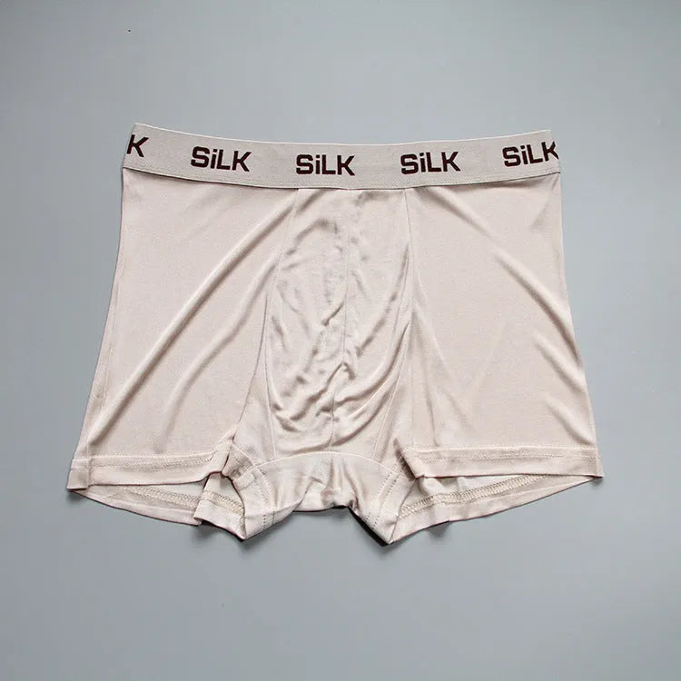 Men's loose-fitting silk shorts in navy blue on a mid-waist.