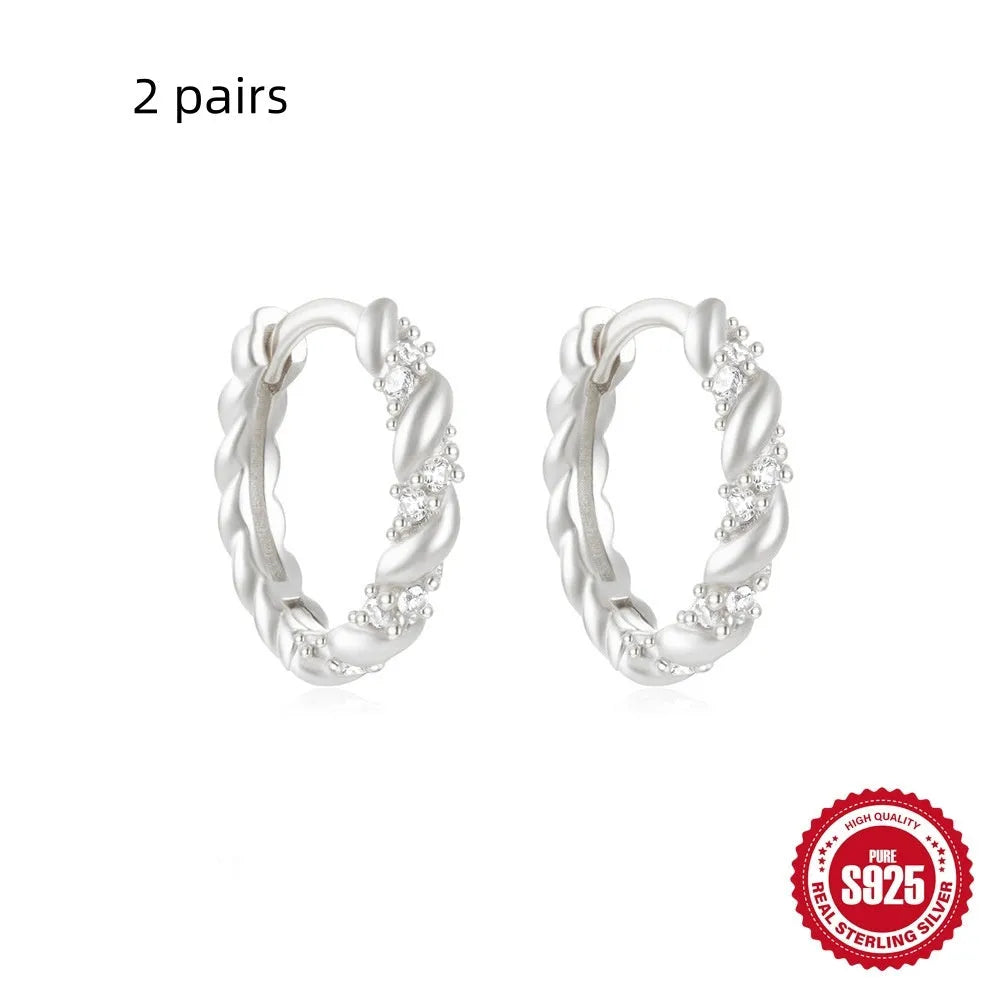 Sterling silver geometric stud earrings with round diamond accents in gold and silver electroplated finishes