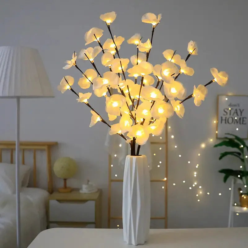 Pink LED Phalaenopsis branch decorative light on a table, 65cm long with fabric cover.