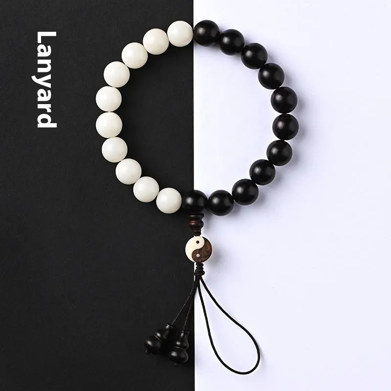 White and black bodhi seed bracelet with eight-diagram pattern, shown as a bracelet and lanyard.
