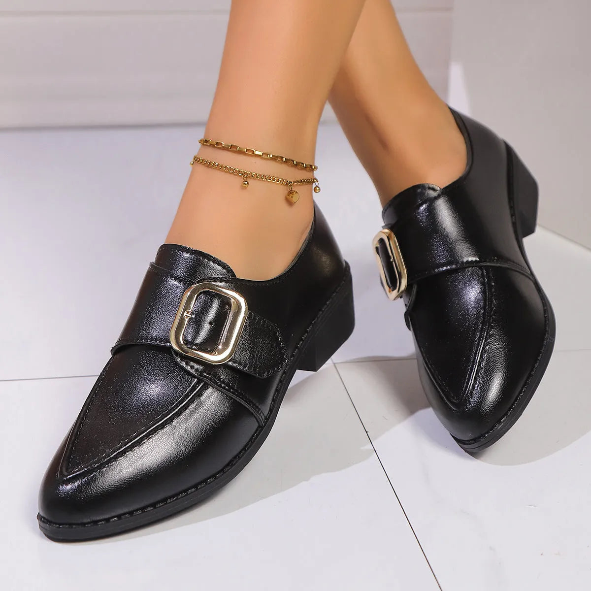 Women's beige loafers with a large decorative bow, showcasing rounded toe and slip-on design.