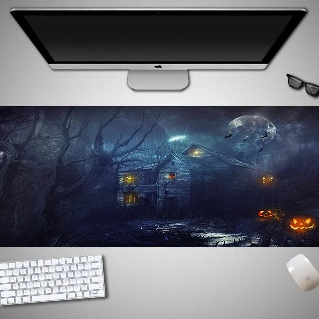Oversized Halloween graphic cloth mouse pad on a desk, showing non-slip rubber base.