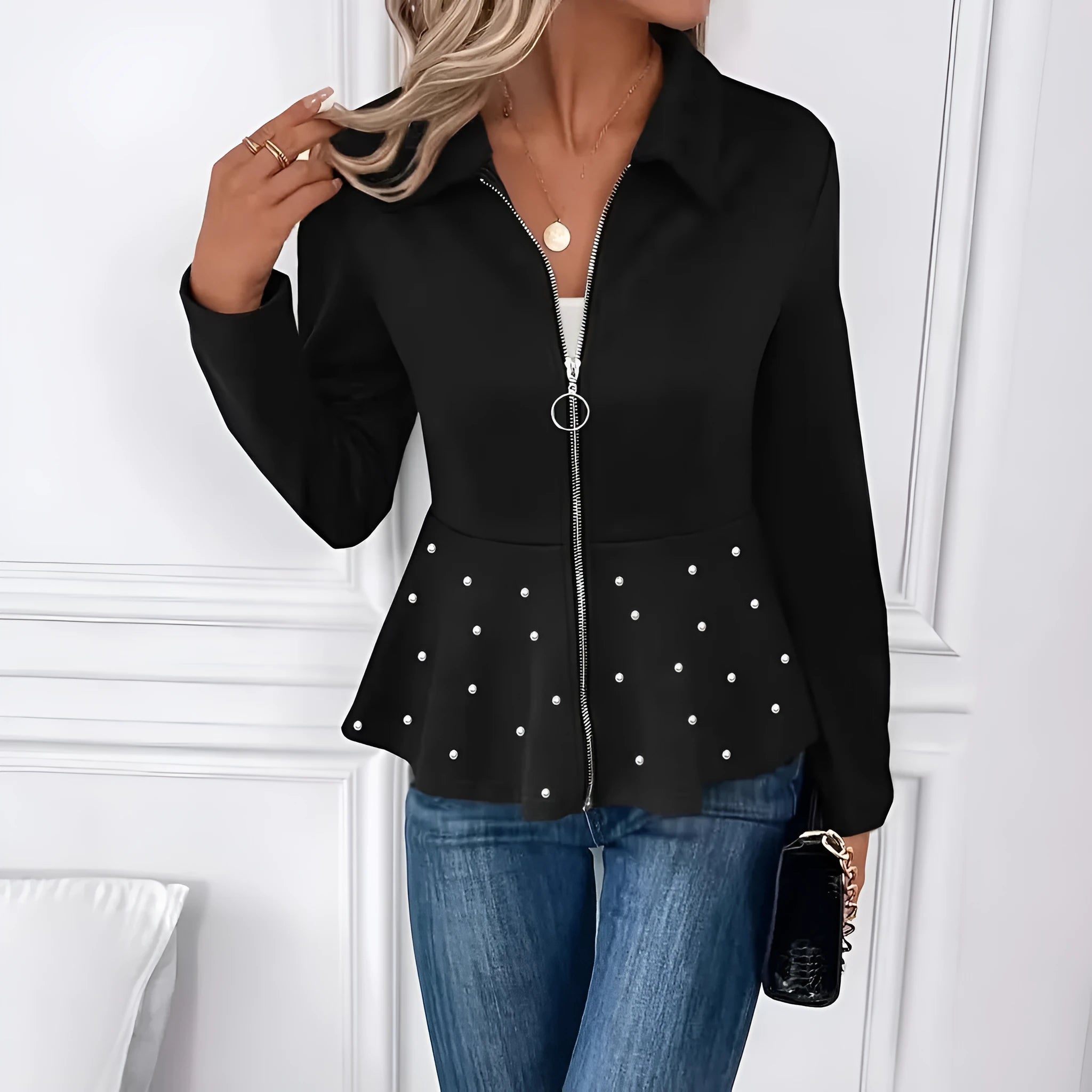 Women's loose fit black coat with a beaded zipper and ruffled hem detail on mannequin.