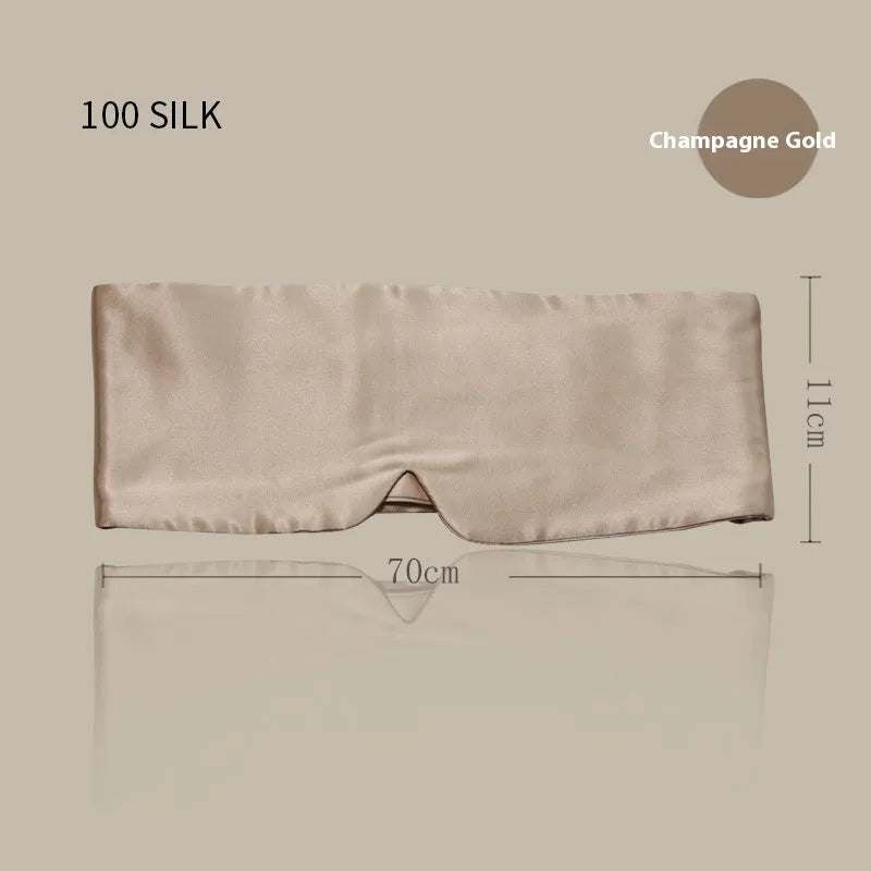 Mulberry silk sleep eye mask shown in champagne gold colour, laid flat on a surface.
