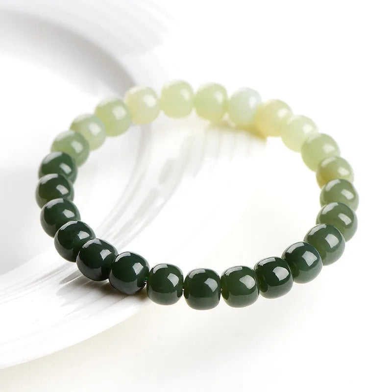 Hetian jade bracelet with clear water gradient beads on wrist.