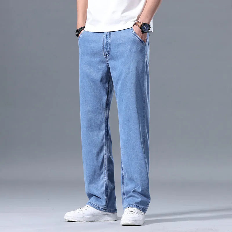 Men's light blue loose straight-leg lyocell jeans laid flat showing zip fly and relaxed fit