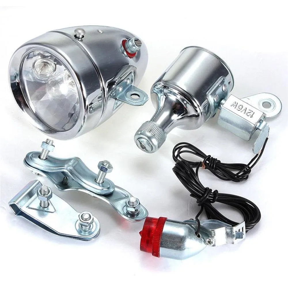 Silver bicycle dynamo generator light kit mounted on a bike frame with front and rear lights