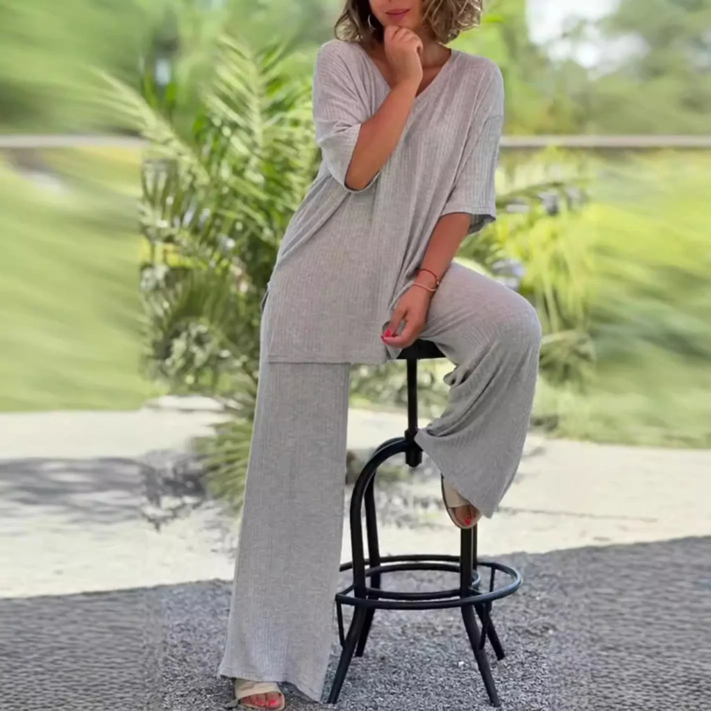 Women's black knitwear two-piece set with long sleeve top and baggy straight trousers on model