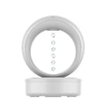 White round anti-gravity air humidifier with levitating water droplets on a desk, USB powered