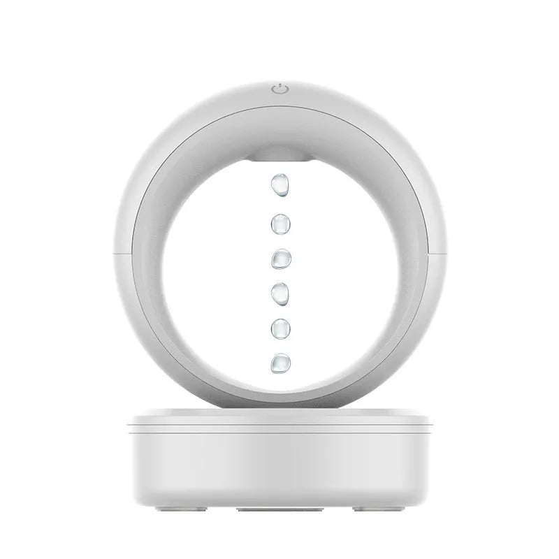 White round anti-gravity air humidifier with levitating water droplets on a desk, USB powered