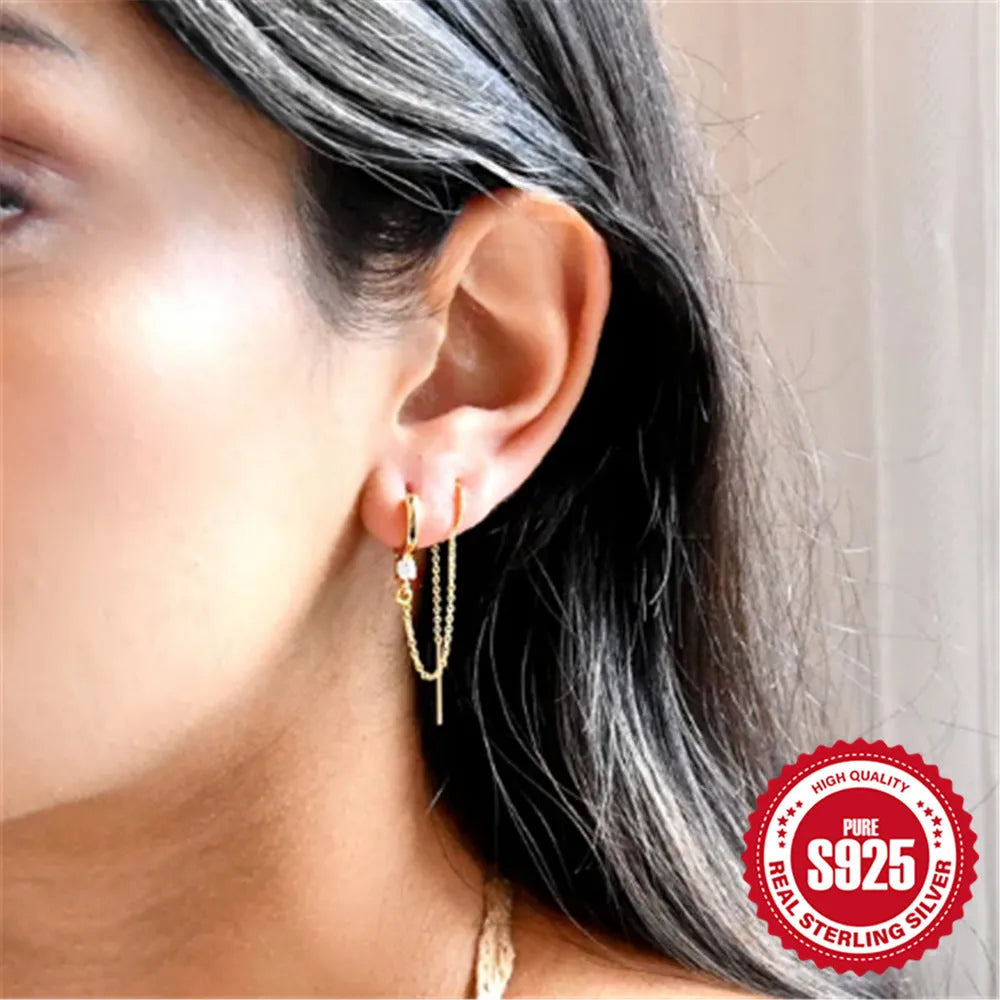 S925 sterling silver stud earrings with a floral motif and dangling gold-coloured tassel chain.