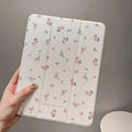 Transparent iPad case with floral cartoon pattern showing tri-fold stand position