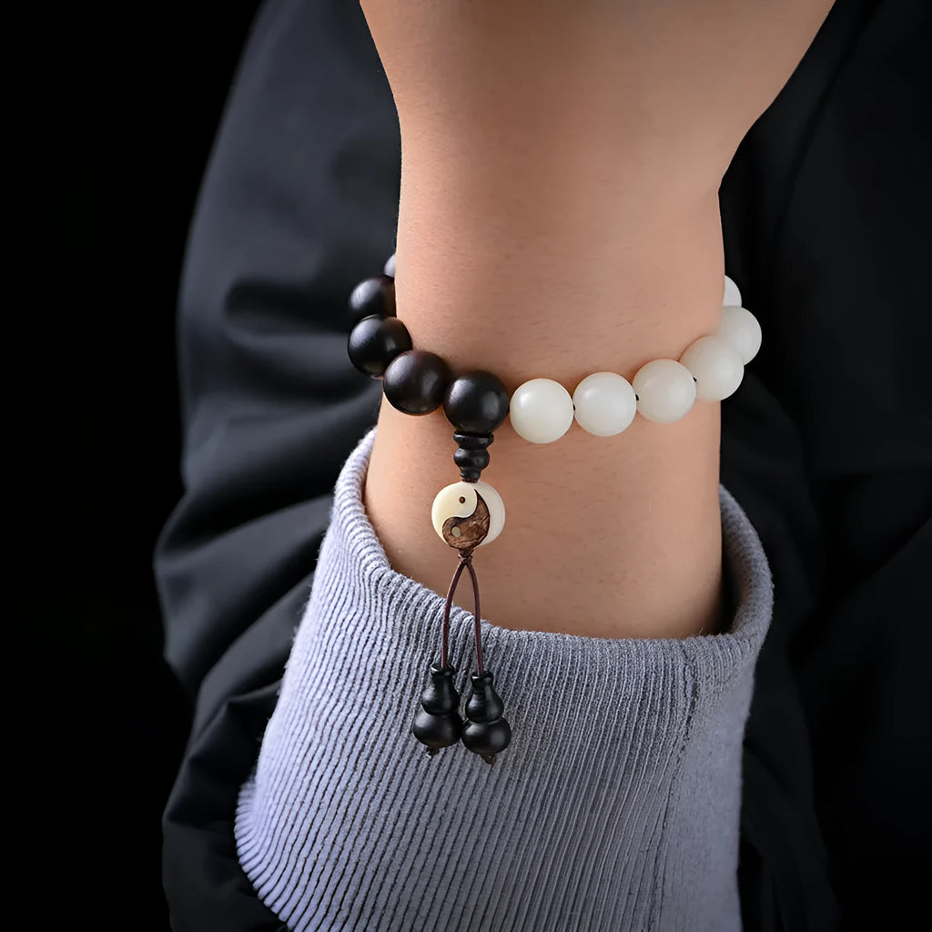 White and black bodhi seed bracelet with eight-diagram pattern, shown as a bracelet and lanyard.