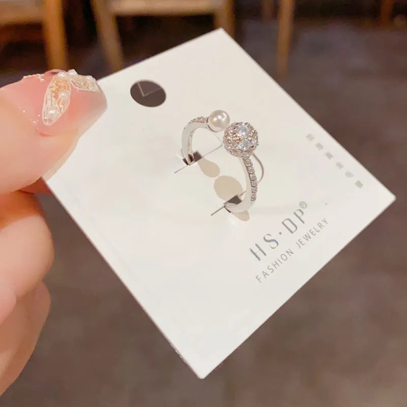 Open-end geometric pearl ring with round zircon accents in gold or silver finish