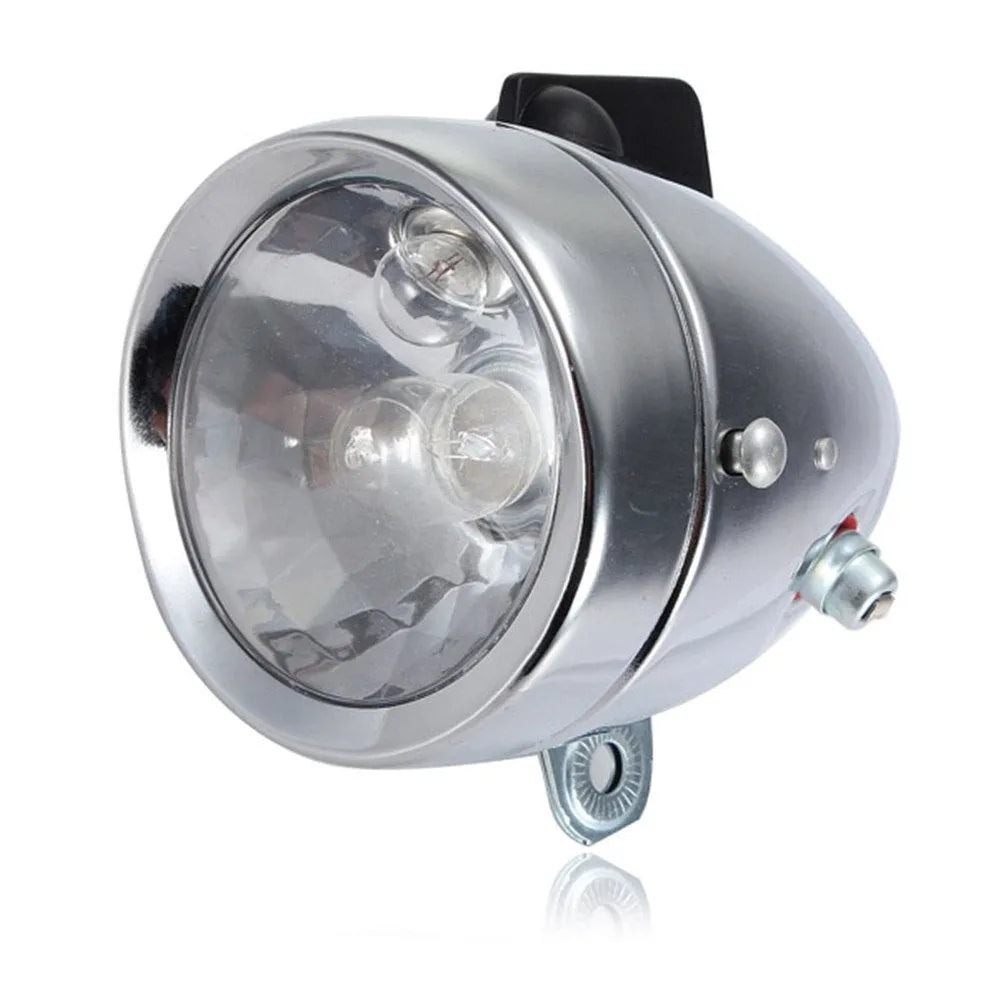 Silver bicycle dynamo generator light kit mounted on a bike frame with front and rear lights
