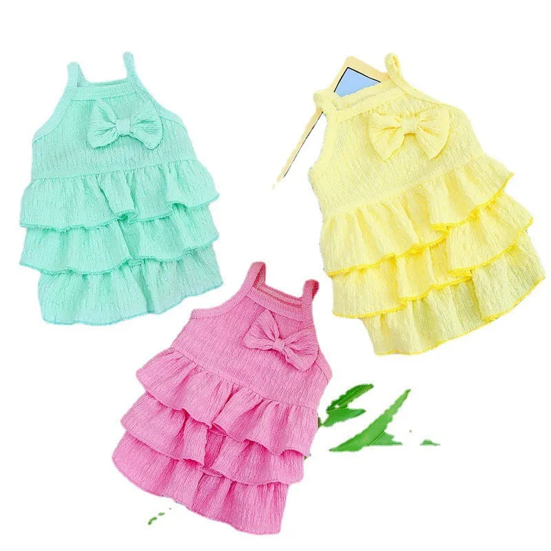 Small dog wearing polyester princess dress with candy layered skirt in water green colour