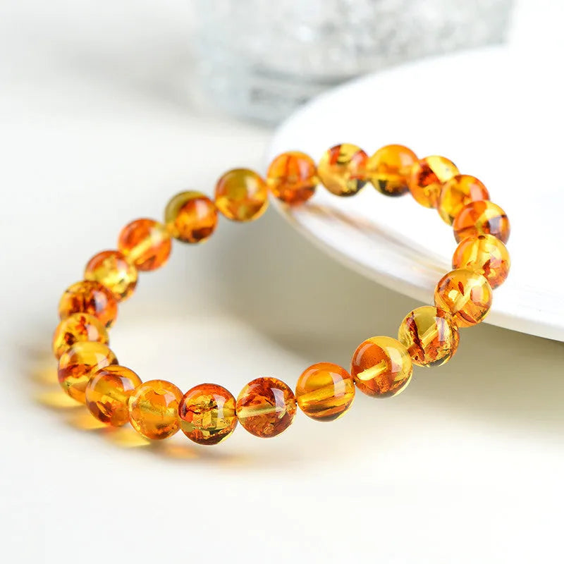 Natural yellow piebald amber bracelet with polished geometry beads and flower spot patterns