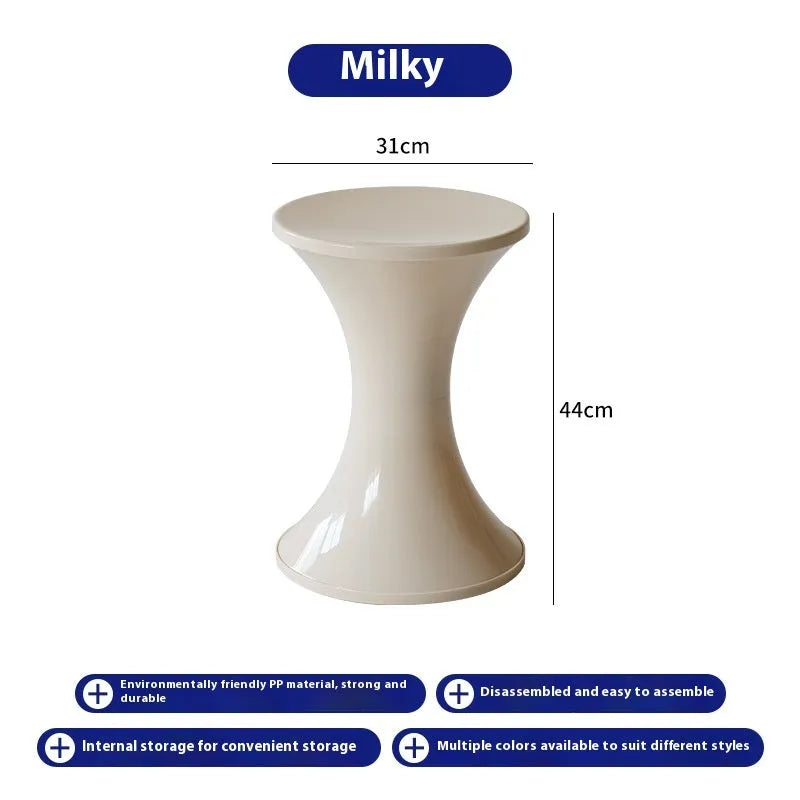 Green hourglass-shaped plastic stool for changing shoes, suitable for children and adults.