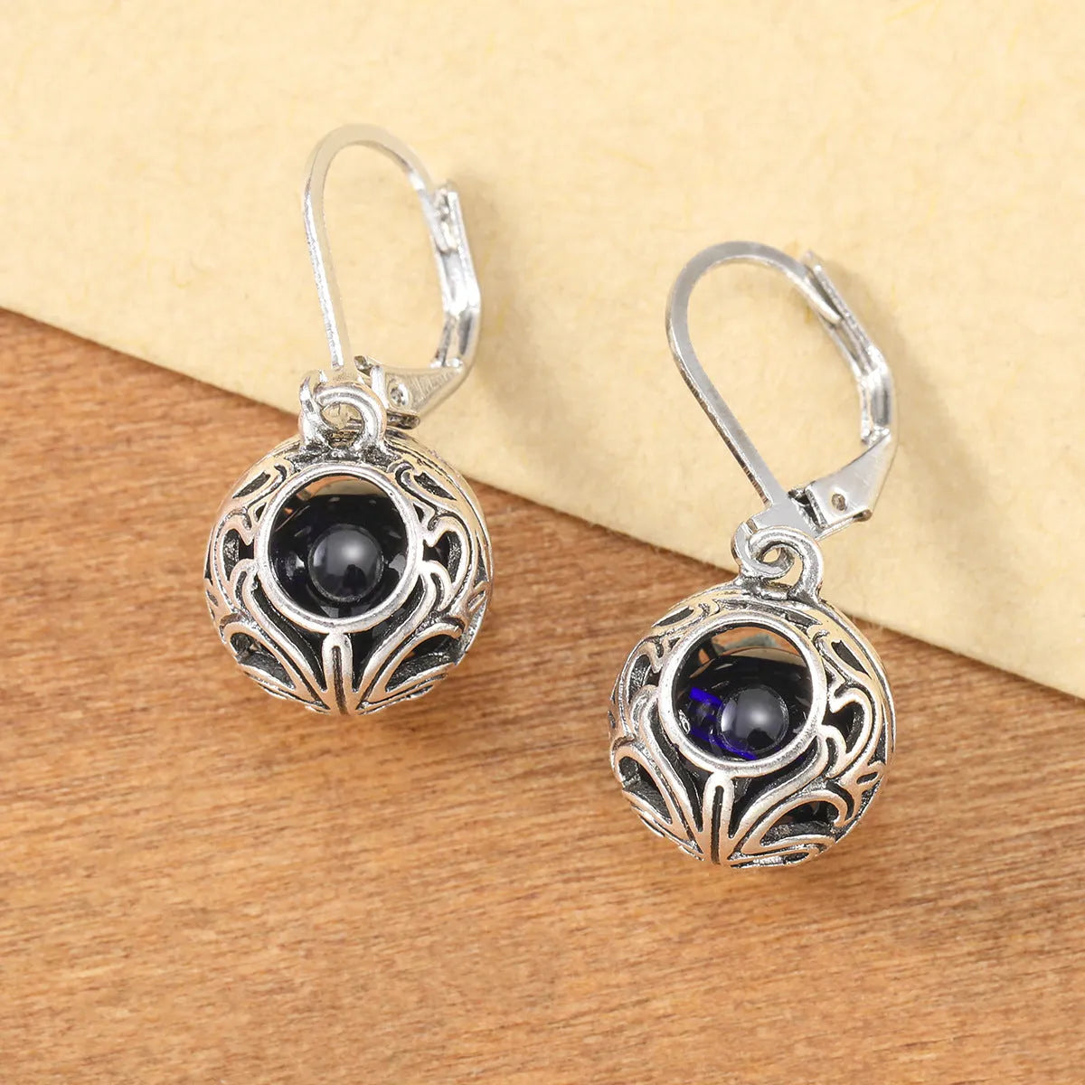 Silver geometric vintage engraving hollow drop earrings with blue gemstone centre