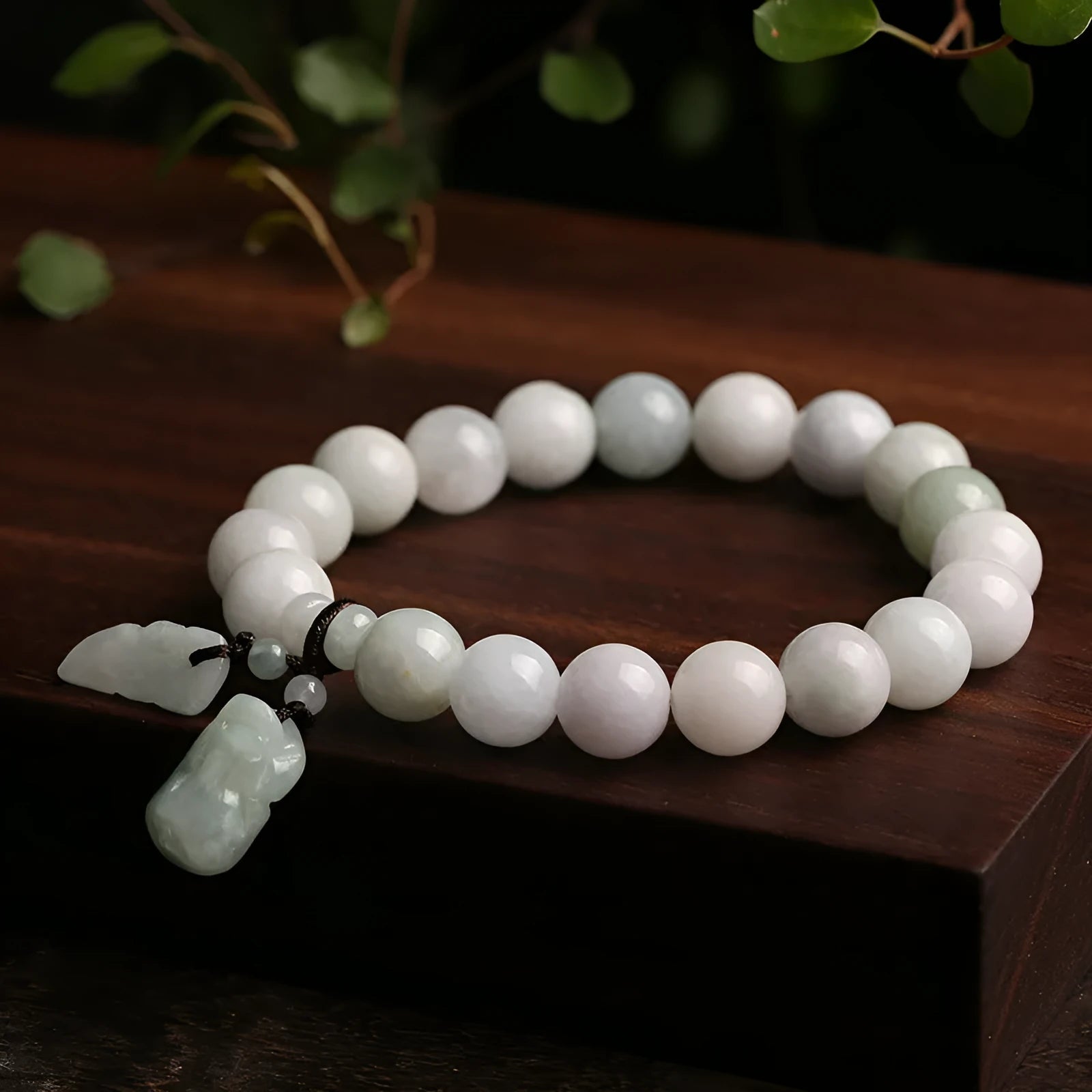 Natural green jade geometric bracelet with an adjustable chain and a hanging Maitreya Buddha charm.