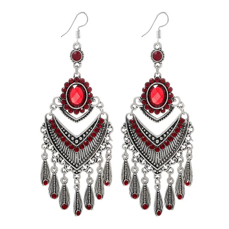 Purple drop-shaped earrings with long fringe detailing, showing retro ethnic style.