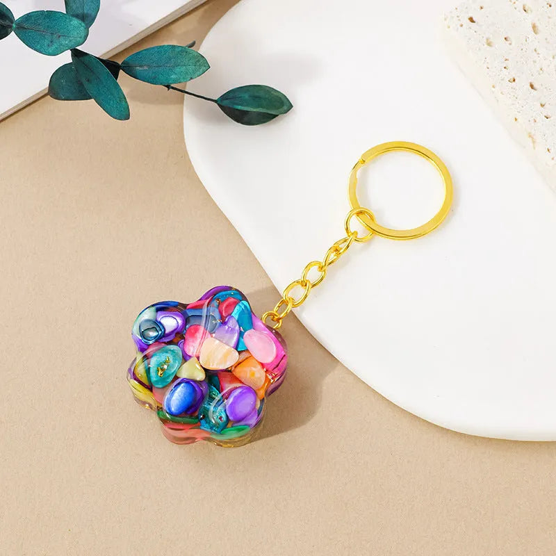 Small natural crystal cat's paw keychain pendant on a metal ring.