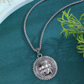 Head pendant sweater chain necklace for men in silver colour with heavy link chain on neutral background