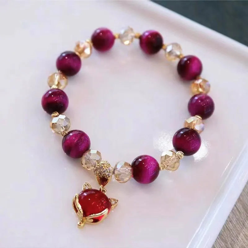 Handmade Vanves Stone Tigereye bracelet on wrist, showing single and double chain options with fox and leather charms.