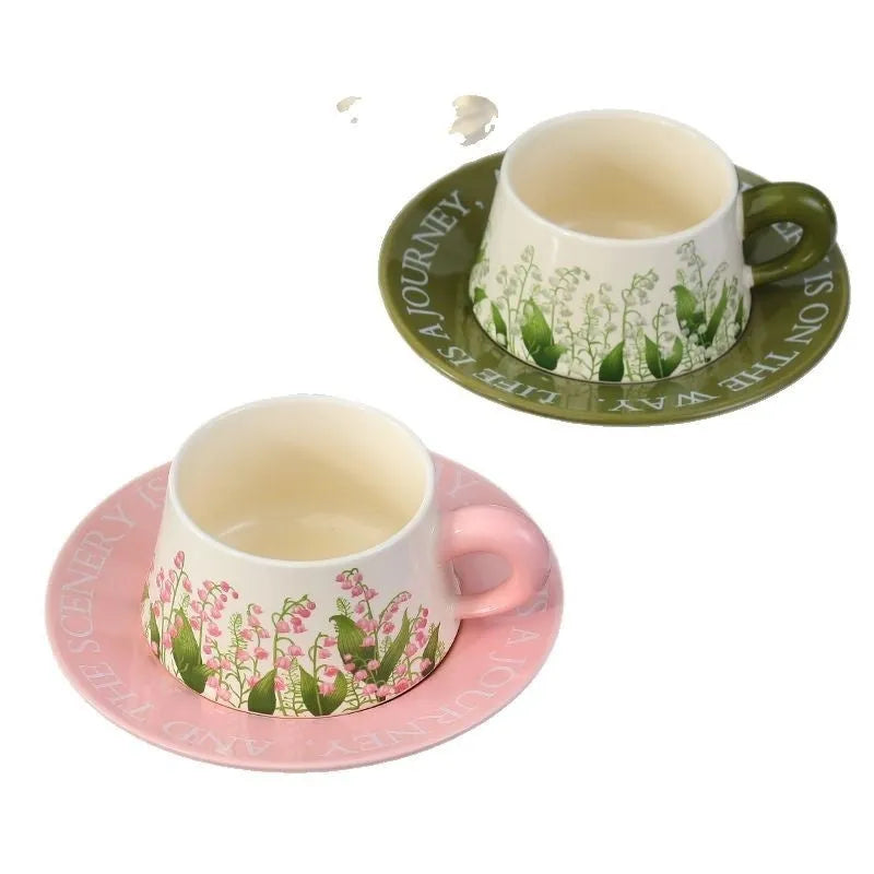 Ceramic coffee cup and saucer set for two with matching spoons in bell-shaped design